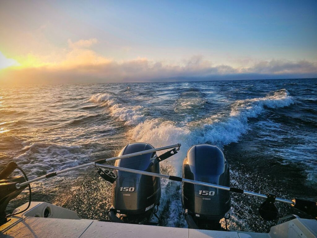 view off the back of a speedboat on the water.